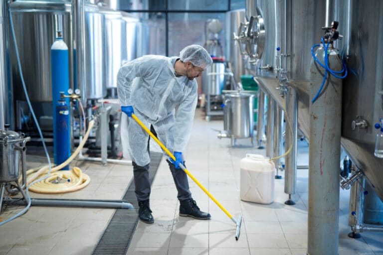 Floor cleaning by industrial cleaning services in a food processing plant