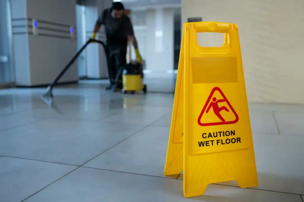 Cleaner with a wet vacuum in a lobby for commercial cleaning