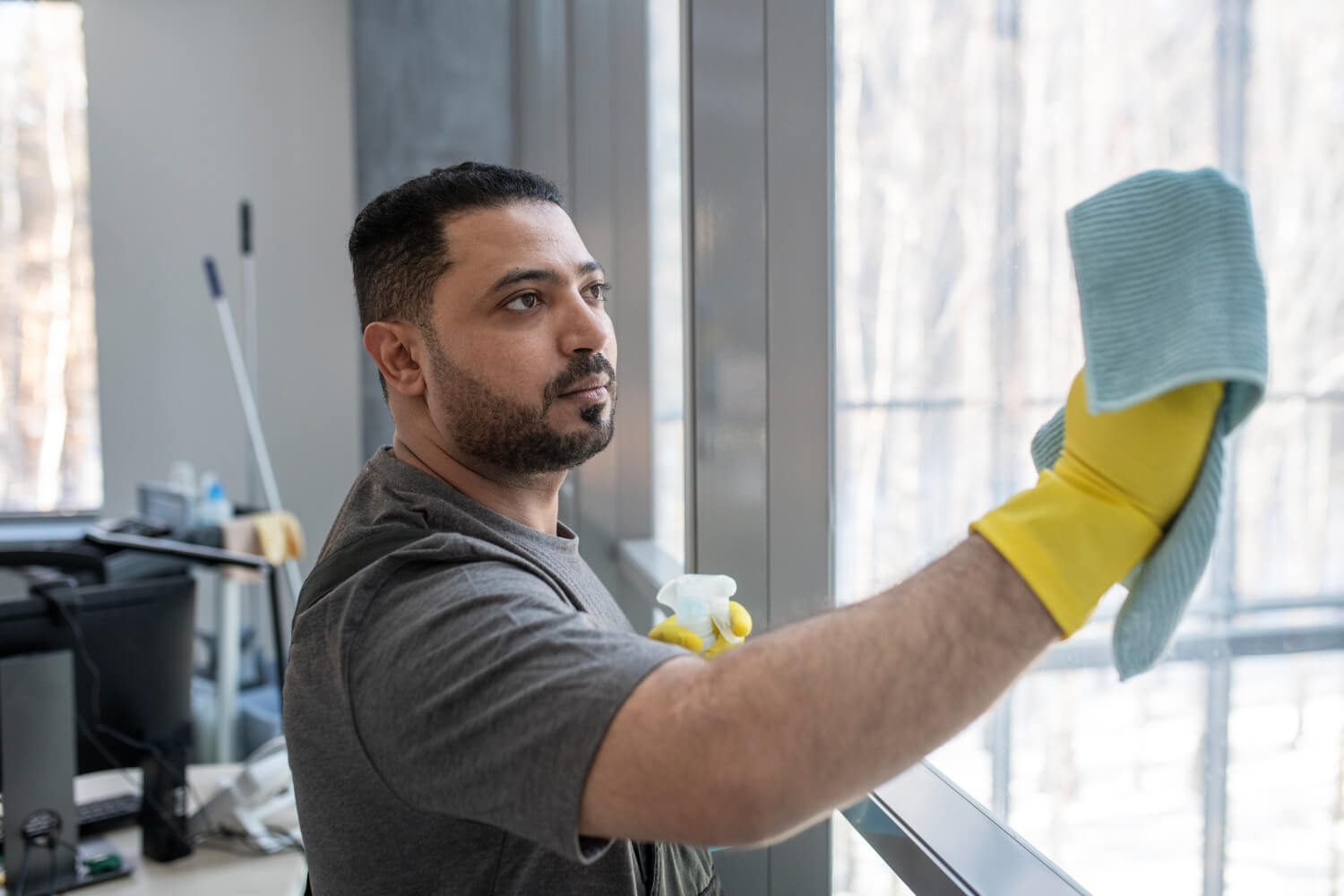 Office cleaner in Sydney wiping a window