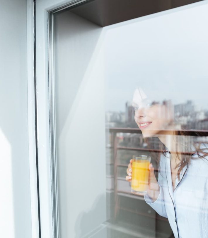 A woman looking through a clean and clear window