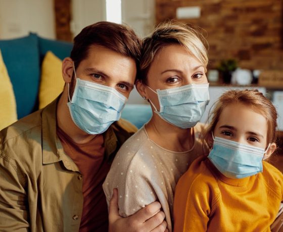 A Covid clean family wearing masks inside their home during the pandemic